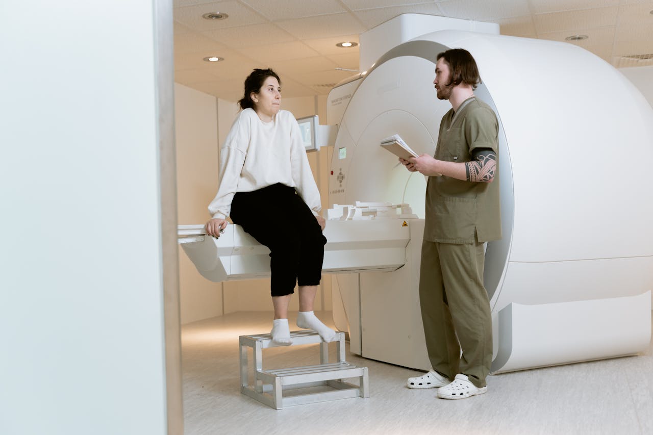 Services A patient consults with a technician in a modern MRI room, highlighting advanced healthcare facilities.